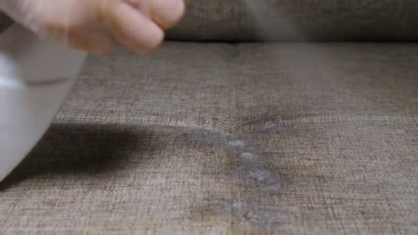 Cleaning furniture surface with wet wipe and spray. Disinfecting sofa fabric at home, apartment or office. with liquid cleaner and wipe. Housewife cleaning house for good family healthcare. 4 k video — Stock Video