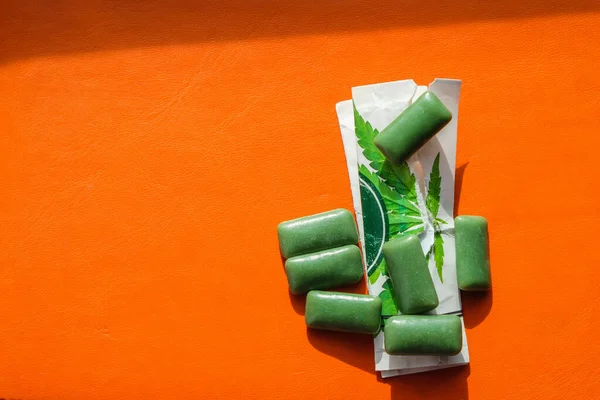 Green Chewing Gum Cannabis Orange Leather Surface Alternative Medicine Concept — Stock Photo, Image