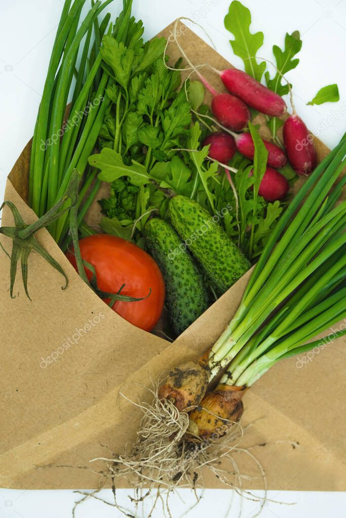 Paper envelope with set of organic vegetables on white surface. Food delivery concept. #LockdownArt