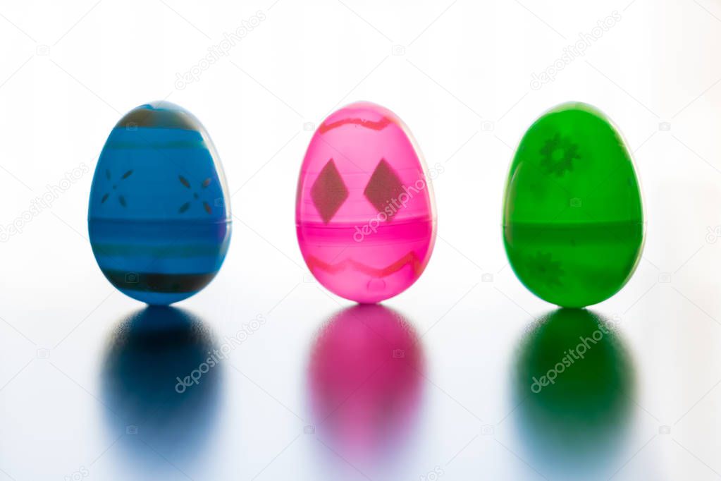 Easter Eggs stand up in front of an all white background. 