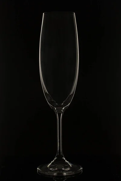 Empty white Sparkling wine, champagne glass on a black background.