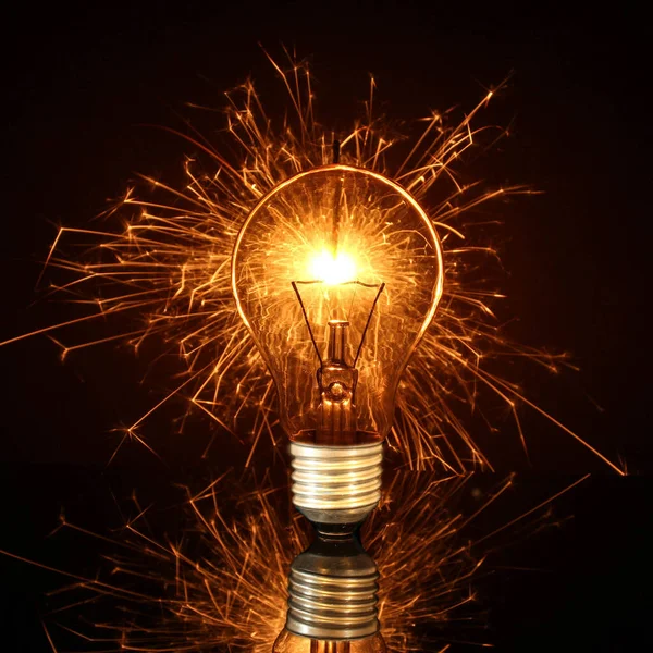 light bulb on the background of a burning sparkler