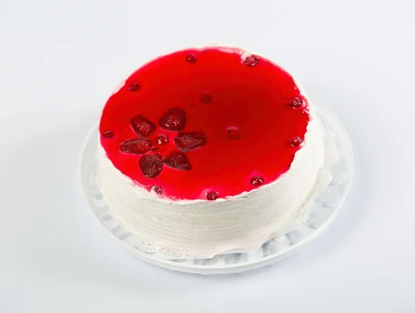 Round biscuit cake decorated with fruit jelly.