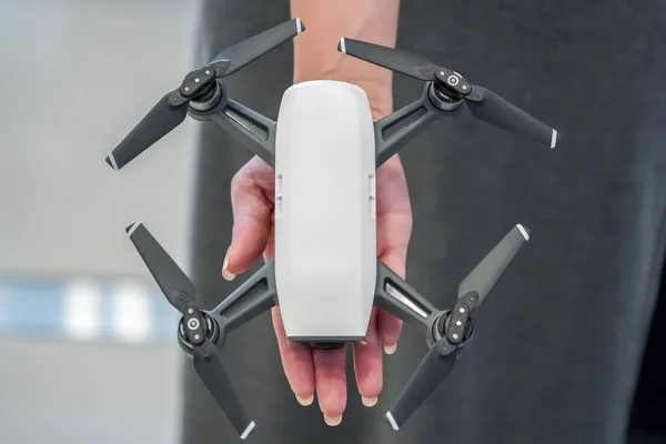 mini Drone on the woman hand in gadget store