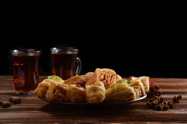 Turkish sweet baklava on plate with Turkish tea.