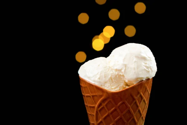 Ice cream stands on a table, on a black background.