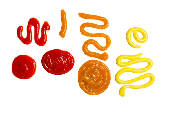 Ketchup e spruzzi di salsa gialla isolati su sfondo bianco . — Foto Stock