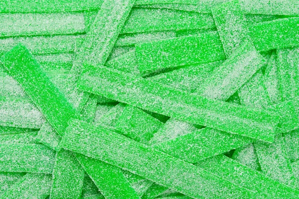 Groene sappige gummy snoepjes achtergrond. Bovenaanzicht. Jelly snoepjes. — Stockfoto