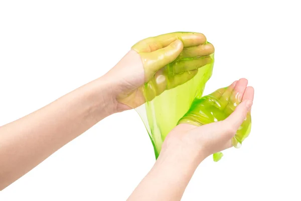 Groen slijm speelgoed in vrouw hand geïsoleerd op wit. — Stockfoto