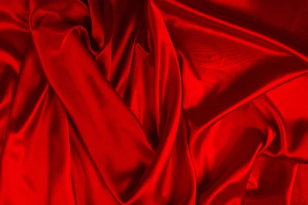赤いシルクやサティンの高級生地の質感は、抽象的なバックとして使用することができます — ストック写真