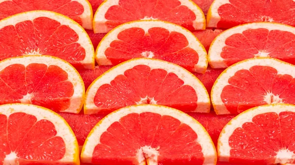 Toranja vermelho suculento fatias fundo. vista superior. — Fotografia de Stock