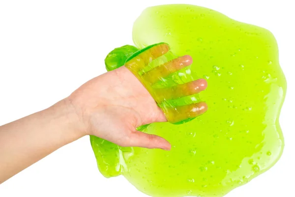Grünes Schleimspielzeug in Frauenhand isoliert auf weißem Grund. — Stockfoto