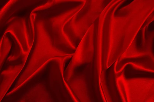 Червоний шовк або атласна розкішна тканина може використовуватись як абстрактна спинка — стокове фото