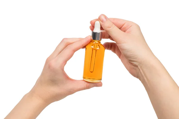 Bottle with oil in woman hand isolated on white. — Stock Photo, Image