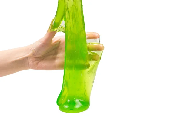 Πράσινο slime παιχνίδι στο χέρι γυναίκα απομονώνονται σε λευκό. — Φωτογραφία Αρχείου