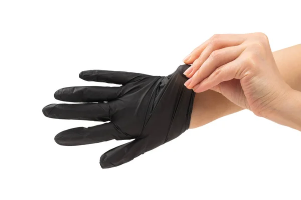 Mujer pone en guantes de goma negro . —  Fotos de Stock