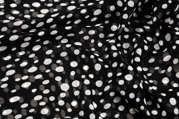 Black and white polka dots fabric texture.