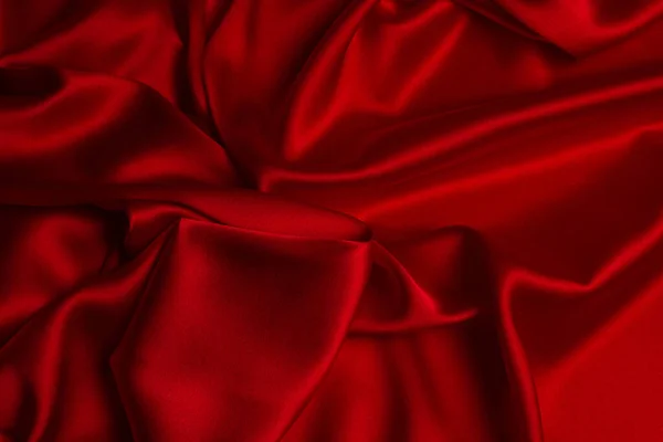 Красный шелк или атласная роскошная текстура ткани может использоваться в качестве абстрактной спины — стоковое фото