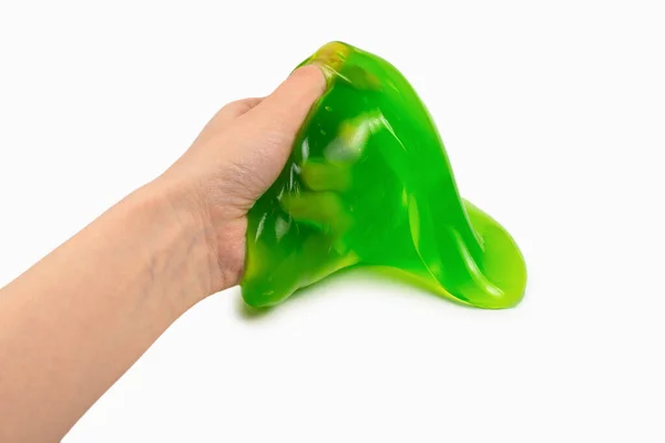 Verde melma giocattolo in donna mano isolata su bianco. — Foto Stock