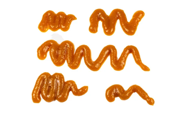 Salpicaduras de salsa de naranja aisladas sobre fondo blanco — Foto de Stock