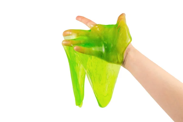 Grünes Schleimspielzeug in Frauenhand isoliert auf weißem Grund. — Stockfoto