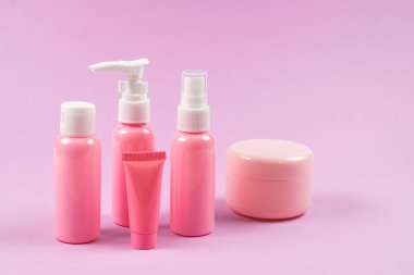 Pembe plastik şişeler hijyen ürünleri, kozmetik ürünleri, pembe arka planda hijyen ürünleri. Boşluğu kopyala. 