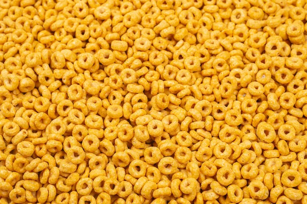 Corn-flakes background and texture. Top view. Honey rings cereal box for morning breakfast.