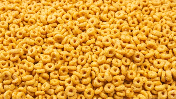 Corn-flakes background and texture. Top view. Honey rings cereal box for morning breakfast.