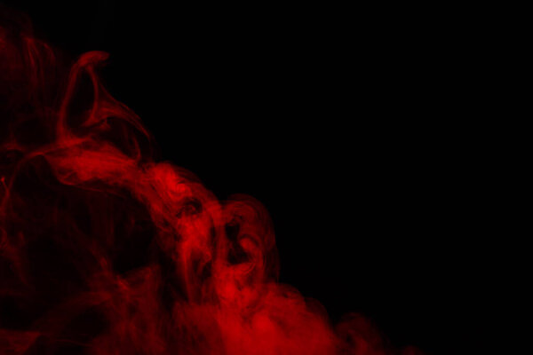 Red steam on a black background. Copy space.