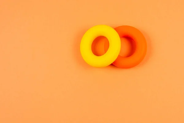 Yellow and orange expander on orange  background.  Copy space.