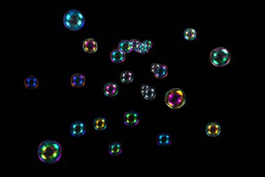 Soap bubbles isolated on a black background. Copy space.  clipart
