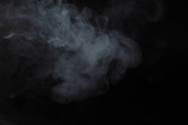 White steam on a black background. Copy space.
