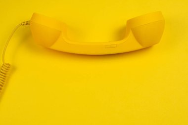 Sarı arka planda sarı bir cep telefonu. Boşluğu kopyala.