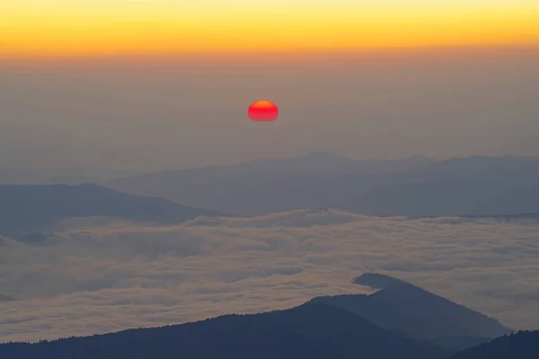 Сцена рассвета с красным солнцем над горами — стоковое фото