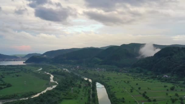 Flying along river, aerial summer landscape of populated valley — 비디오