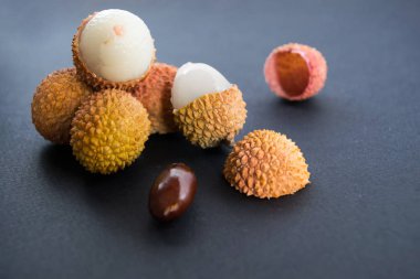 Bir taş ve koyu mavi (siyah) zemin üzerine parlak, sarsıntı cilt Lychee (Çin) 