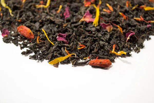 Aromatic, pungent, black tea with dry berries and flowers. Side view.