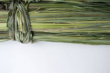 A bunch of dry green lemongrass on a white background clipart