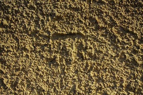 Structuur van de pleister op de muur, de achtergrond van het gebarsten, stenen surfac — Stockfoto