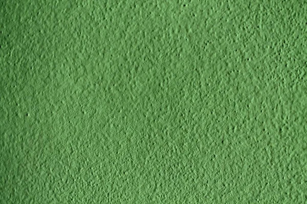 Textura verde de yeso en la pared, fondo agrietado, superficie de piedra . — Foto de Stock