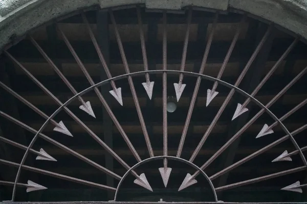 Metal fence decorated with sharp arrows into round form, Brown steel arrow