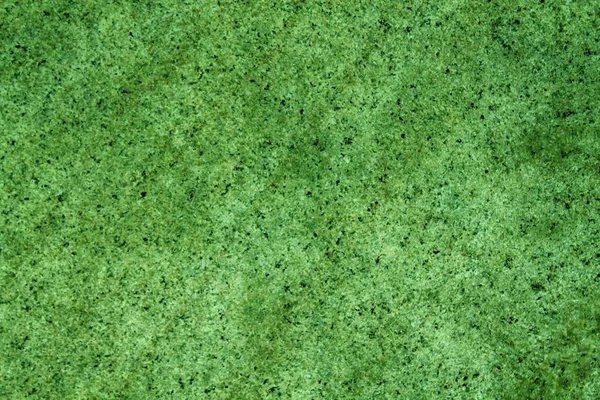 Elegante groene stenen muur uit kleine vierkante delen. Rots textuur oppervlak — Stockfoto