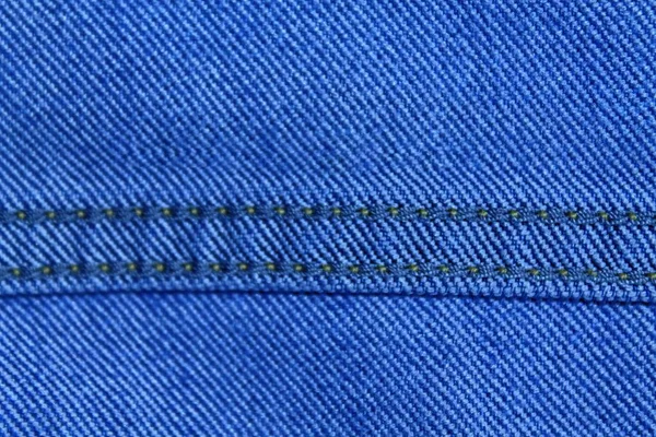 Textura de mezclilla azul con costura beige para fondo vaquero — Foto de Stock