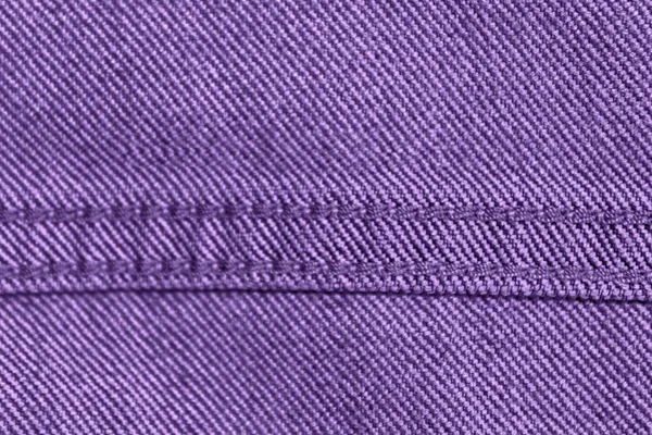 Tekstur Denim ungu dengan jahitan beige untuk latar belakang jeans — Stok Foto