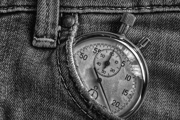Vintage antiques Stopwatch, in old worn dark denim pocket, value measure time, old clock arrow minute, second accuracy timer record