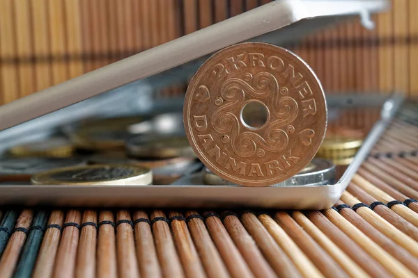 Stapel von Mark-Münzen mit einer Stückelung von 2 Kronen (Krone) in Spiegel spiegeln Brieftasche liegt auf hölzernem Bambus-Tischhintergrund — Stockfoto