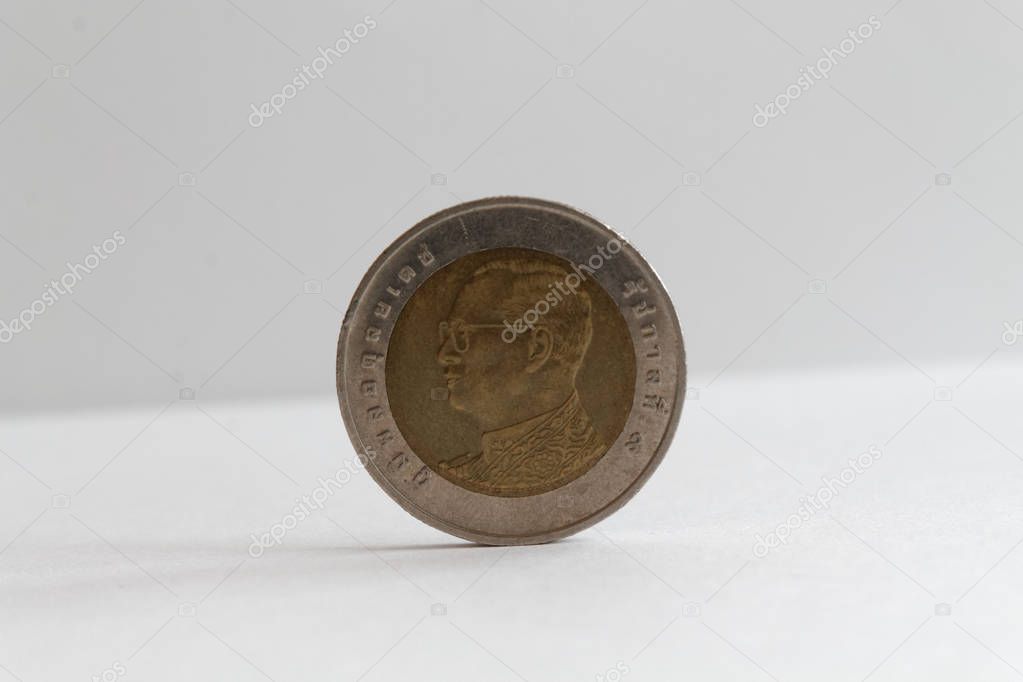 One Thai coin denomination is ten baht lie on isolated white background - back side