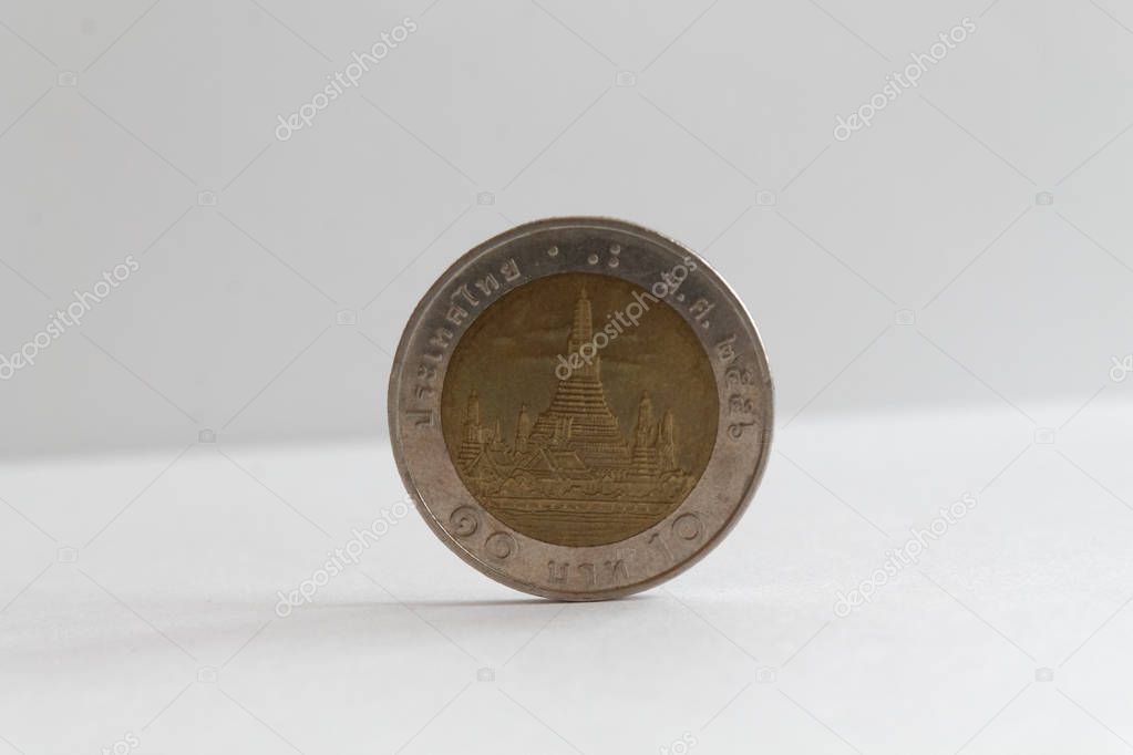 One Thai coin denomination is 10 baht lie on isolated white background