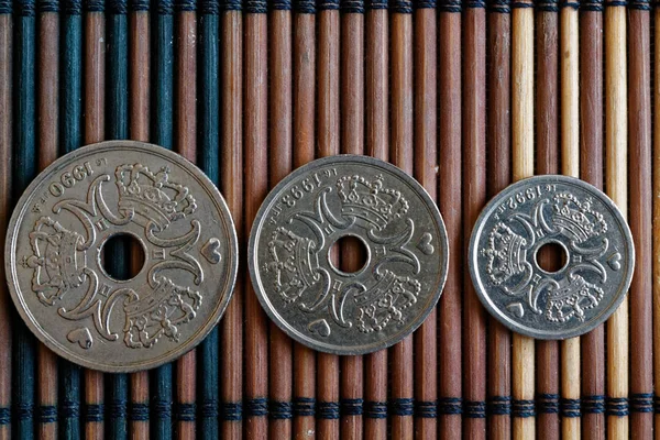 Tři nominální hodnota mince Dánsko je 5, 2 a 1 krone (koruna) - zadní strana leží na stole dřevěné bambusové, dobré pro pozadí nebo pohlednice — Stock fotografie