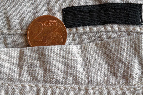 Euro koin dengan denominasi dua sen euro di saku celana linen dengan garis hitam — Stok Foto